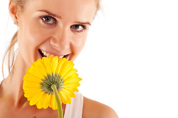Image showing woman smelling a yellow flower 