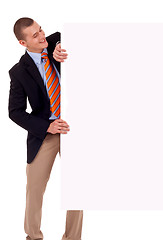 Image showing Business man holding blank poster