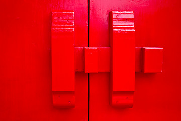 Image showing Red door with wood lock 