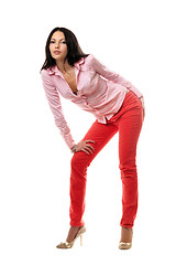 Image showing Playful young brunette in red jeans