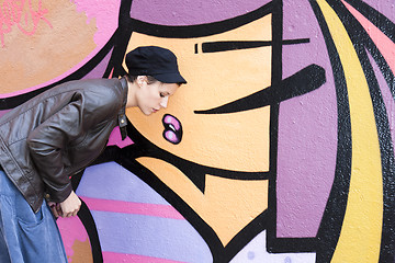 Image showing  woman in front of a graffiti