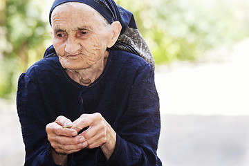 Image showing Senior woman eating cherry