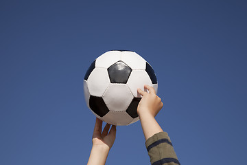 Image showing Hands holding a soccer ball