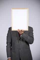 Image showing businessman holding a whiteboard