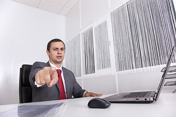 Image showing Mature businessman at the office pointing to you