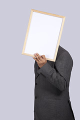 Image showing businessman holding a whiteboard