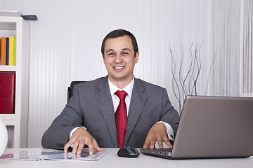 Image showing Mature businessman working at the office