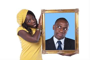 Image showing African woman holding a portrait of a businessman