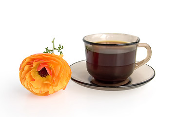 Image showing A cup of coffee and orange flower