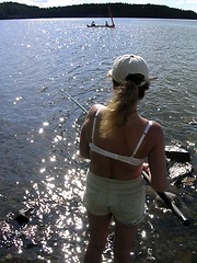 Image showing Woman fishing and people canoing