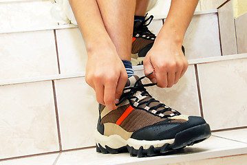 Image showing Boy tying his shoe