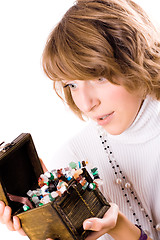 Image showing beautiful girl looks at wooden jewelry box