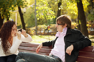 Image showing Woman photographs guy