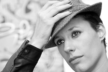 Image showing Woman holding her hat