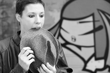 Image showing Woman eating the brim of his hat