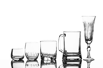 Image showing Various glass glasses on a white background with reflexion