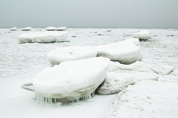Image showing Winter. The stones which have frozen and covered with ice on sea