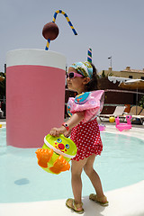 Image showing Child playing by pool