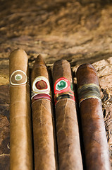 Image showing hand rolled nicaraguan cigars on tobacco leaf