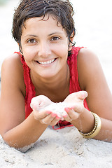 Image showing woman in red lying on a sand