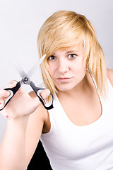 Image showing attractive young woman with scissors