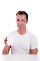 Image showing Portrait of a happy man, drinking a drink