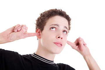 Image showing Young man, holding fingers in his ears, bored, not listening