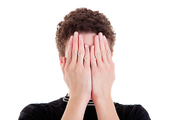 Image showing young man covering his face