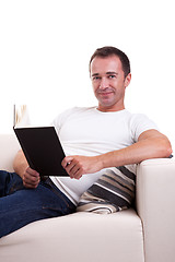 Image showing man on the sofa reading a book