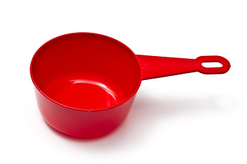 Image showing Red plastic measuring cup isolated on white