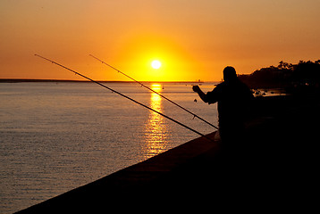 Image showing Man fishing on sunset 