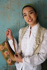 Image showing Asian woman holding a handbag