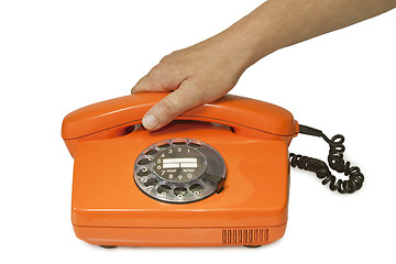 Image showing Old orange telephone 