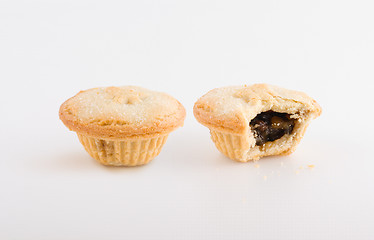 Image showing Two fruit pies, one bitten
