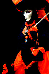 Image showing A masked woman on black background
