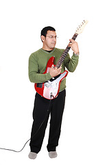 Image showing Man standing with guitar.