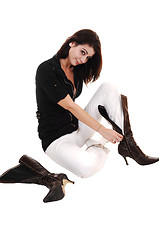 Image showing Girl putting on boots.