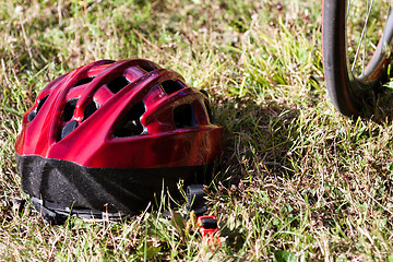 Image showing Red helmet lying on the grass