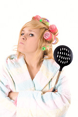 Image showing housewife with curlers and skimmer