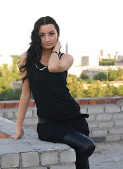 Image showing Girl sitting on roof