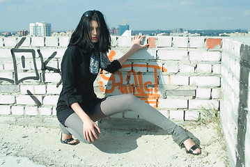 Image showing Young woman on roof