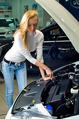 Image showing Young woman at broken car