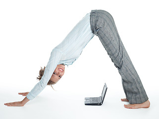 Image showing Flexible businesswoman with laptop