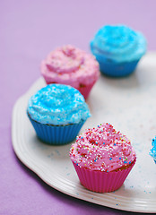 Image showing freshly baked pink and blue cupcakes 