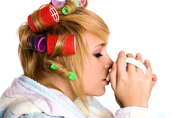 Image showing housewife with curlers and cup