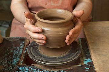 Image showing Potter shows just created a pot