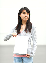 Image showing girl holding empty white board