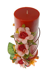 Image showing Large red candle with the flower decoration