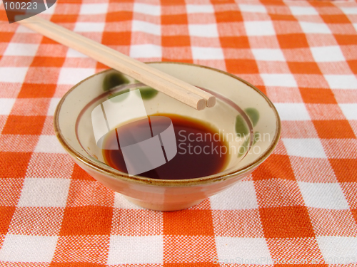 Image of Soy sauce and chopsticks on a home table