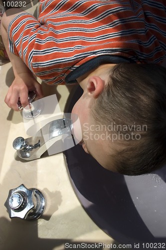 Image of Little Boy Drinking Water from the Faucet